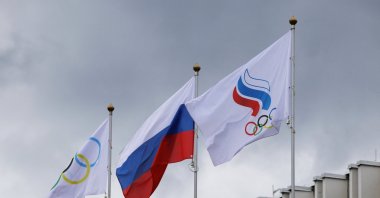 (L-R) The International Olympic Committee (IOC), Russian and Russian Olympic Committee (ROC) flags fly at the Committee's headquarters, Moscow, Russia, July 8, 2026. (Reuters Photo)