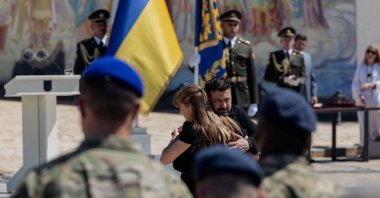 Ukrainian President Volodymyr Zelenskyy hugs a woman after her father was posthumously awarded an order for bravery during a ceremony to mark the Day of Ukrainian Statehood, Kyiv, Ukraine, July 15, 2026. (AFP Photo)