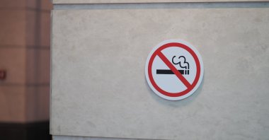A no smoking sign displayed on a wall in a public area. (Shutterstock Photo)