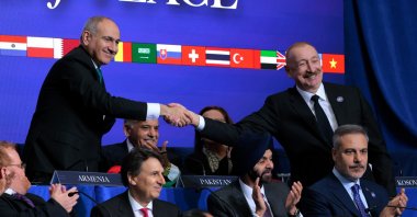Prime Minister of Armenia Nikol Pashinyan (L) shakes hands with President of Azerbaijan Ilham Aliyev during the inaugural meeting of the Board of Peace in Washington, D.C., Feb. 19, 2026. (Getty Images Photo)