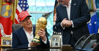 U.S. President Donald Trump, joined by FIFA President Gianni Infantino (R), holds the World Cup Trophy as he makes an announcement in the Oval Office of the White House, Washington, D.C., U.S., Aug. 22, 2025. (AFP Photo)