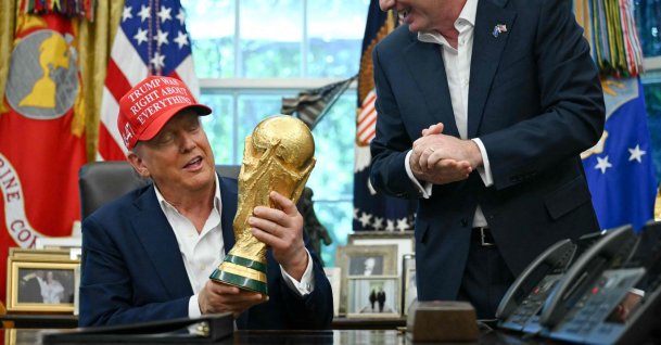 U.S. President Donald Trump, joined by FIFA President Gianni Infantino (R), holds the World Cup Trophy as he makes an announcement in the Oval Office of the White House, Washington, D.C., U.S., Aug. 22, 2025. (AFP Photo)