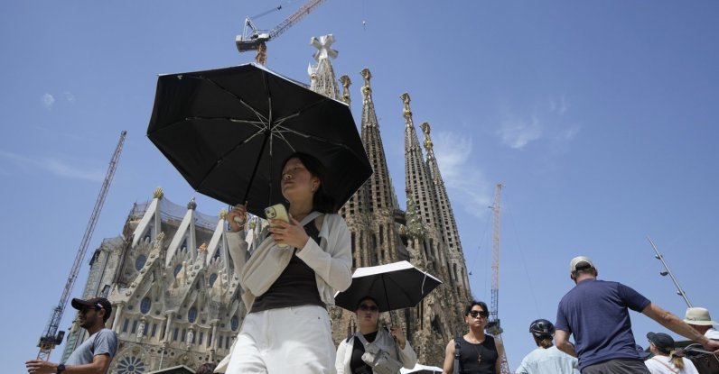 Tourists protect themselves from the sun with umbrellas near the Sagrada Familia, Barcelona, Spain, July 15, 2026. (EPA Photo)