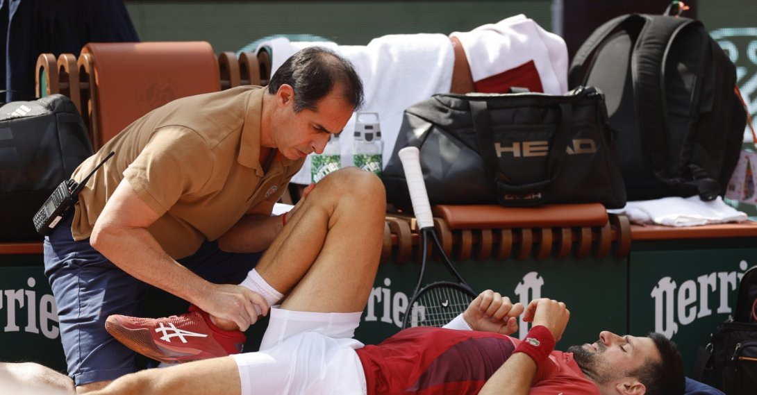 Serbia's Novak Djokovic receives medical assistance for his right knee during his fourth-round match of the French Open tennis tournament against Argentina's Francisco Cerundolo at the Roland Garros stadium, Paris, France, June 3, 2024. (AP Photo)