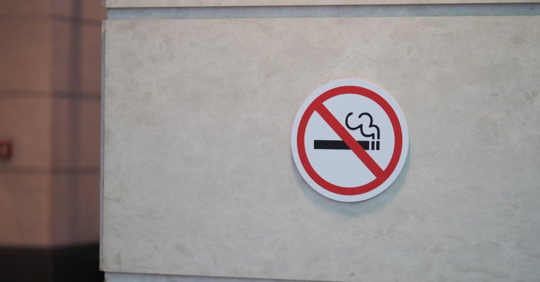 A no smoking sign displayed on a wall in a public area. (Shutterstock Photo)