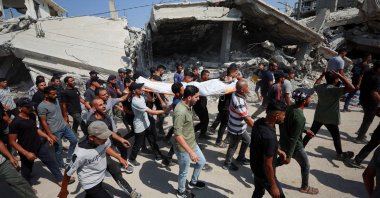 Mourners react while carrying a body during the funeral of three Palestinians, who were killed in an Israeli strike, according to medics, Gaza City, Palestine, July 16, 2026. (Reuters Photo)