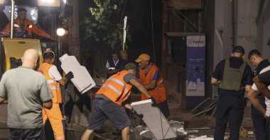 Communal workers clean debris at the site of a Russian strike on a residential area, Odesa, Ukraine, July 16, 2026. (EPA Photo)