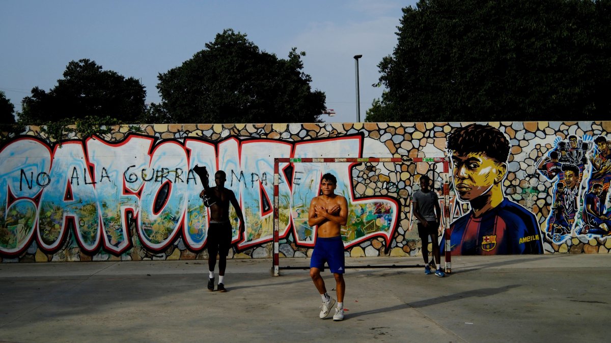Residents play football in a park as one of them does Lamine Yamal's trademark "304" hand gestures after scoring goals, a reference to the neighborhood's postal code, at the Rocafonda neighborhood in Mataro, Barcelona, Spain, July 16, 2026. (Reuters Photo)