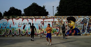 Residents play football in a park as one of them does Lamine Yamal's trademark "304" hand gestures after scoring goals, a reference to the neighborhood's postal code, at the Rocafonda neighborhood in Mataro, Barcelona, Spain, July 16, 2026. (Reuters Photo)