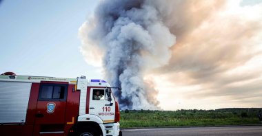 Firefighters drive past the smoke of a fire at the Russian e-commerce firm Wildberries' logistics complexes in the town of Elektrostal, Moscow, Russia, July 18, 2026. (AFP Photo)
