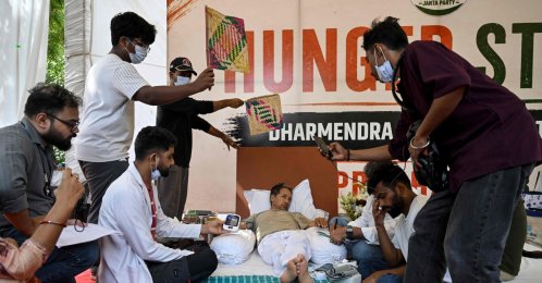 Cockroach Janta Party (CJP) founder Abhijeet Dipke (2R) reacts as doctors check activist Sonam Wangchuk’s vital signs during his hunger strike demanding the resignation of India’s Education Minister Dharmendra Pradhan over alleged examination irregularities, New Delhi, India, July 15, 2026. (AFP Photo)