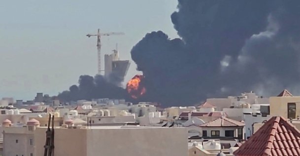This screen grab, taken from UGC video footage posted on social media on July 18, 2026, shows a plume of black smoke and flames billowing over the town of Mangaf, Kuwait City, Kuwait. (AFP Photo)