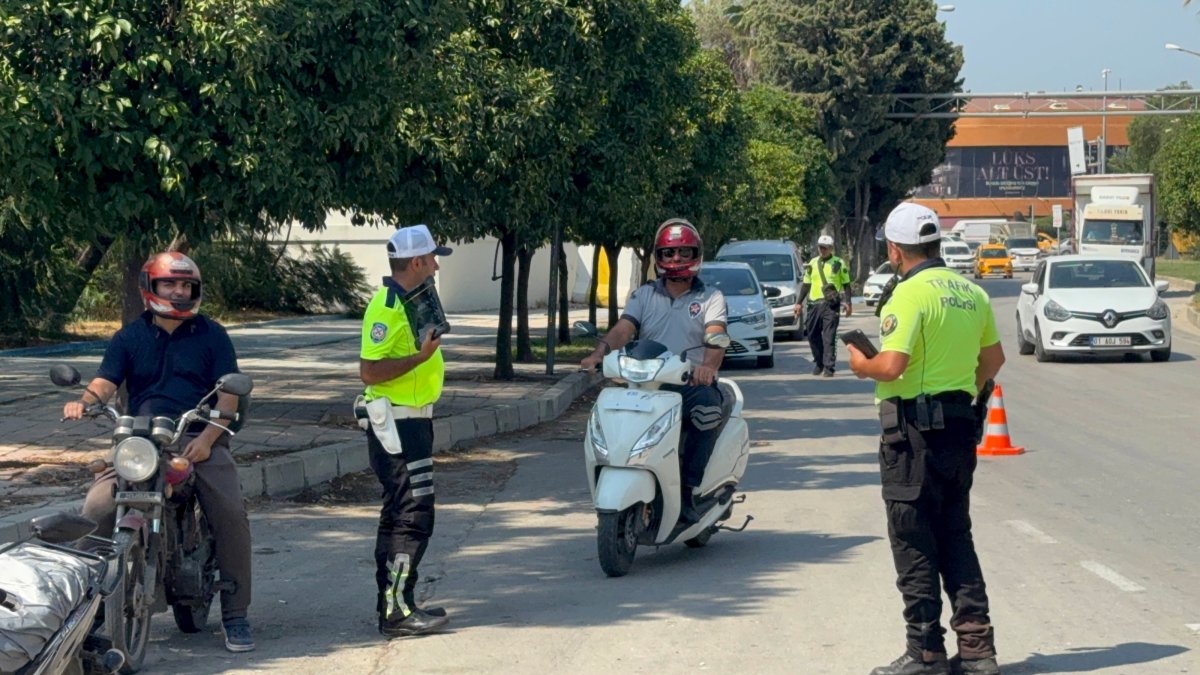 Traffic police fine motorcyclists during a road safety inspection, Adana, Türkiye, July 16, 2026. (AA Photo)