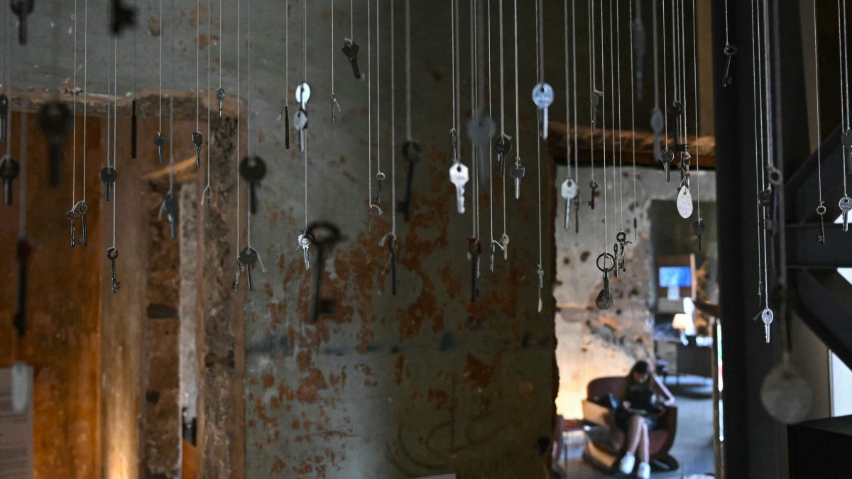 Keys of destroyed houses hang from the ceiling at "Hkeeli ya Jnoub" ("Tell me, O south") exposition, which aims to preserve the memory of villages destroyed by Israel, Beirut, Lebanon, July 17, 2026. (AFP Photo)