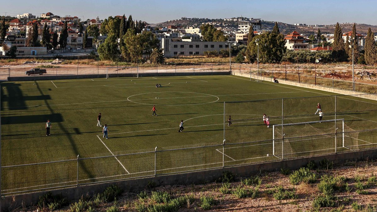 Palestinian teens play football in Turmus Ayya, northeastern Ramallah, with the Israeli settlement of Shilo visible in the background, occupied West Bank, Palestine, June 28, 2026. (AFP Photo)