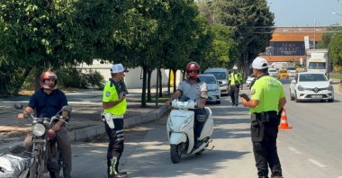 Traffic police fine motorcyclists during a road safety inspection, Adana, Türkiye, July 16, 2026. (AA Photo)