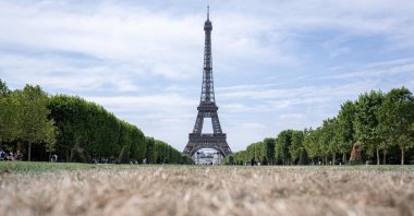 The Eiffel Tower and dried-out grass on the Champ de Mars, Paris, France, July 15, 2026. (AFP Photo)