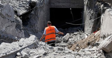 Communal workers clear debris from an underground pedestrian crossing damaged by missile strikes in Kyiv, Ukraine, July 19, 2026. (AFP Photo)