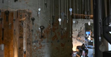 Keys of destroyed houses hang from the ceiling at "Hkeeli ya Jnoub" ("Tell me, O south") exposition, which aims to preserve the memory of villages destroyed by Israel, Beirut, Lebanon, July 17, 2026. (AFP Photo)