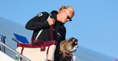 Norway's striker Erling Braut Haaland carries a taxidermy raccoon as he gets off the plane, Oslo, Norway, July 13, 2026. (AFP Photo)
