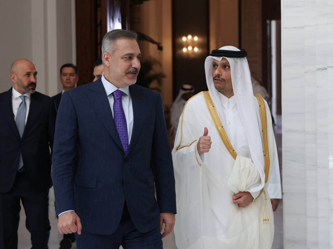 Foreign Minister Hakan Fidan (L) walks with Qatar's Prime Minister and Foreign Minister Sheikh Mohammed bin Abdulrahman Al Thani before their meeting, Doha, Qatar, July 19, 2026. (AA Photo)