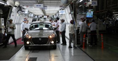 Employees check a fully assembled car at the manufacturing plant of Maruti Suzuki in Manesar, northern state of Haryana, India, Sept 26, 2023. (Reuters Photo)