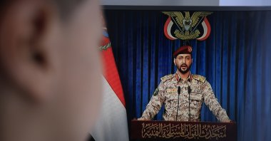 A person watches Houthi military spokesperson Yahya Sarea deliver a televised statement in Sanaa, Yemen, July 20, 2026. (EPA Photo)