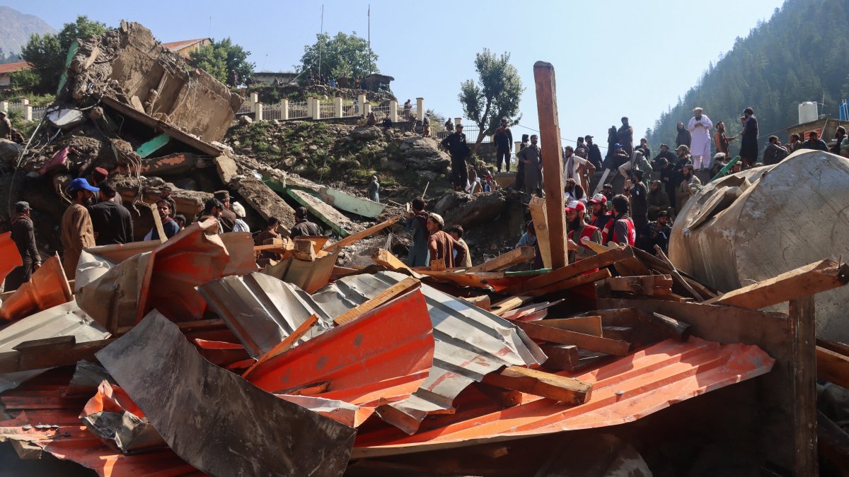 People inspect the destruction and look for belongings after floodwaters swept through Parun, the capital of Nuristan province, Afghanistan, July 21, 2026. (Reuters Photo)