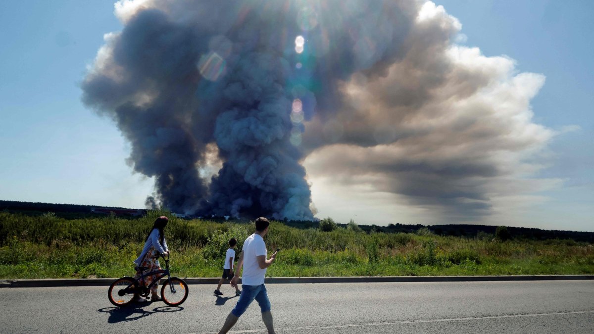 Local residents walk past the smoke of a fire at the Russian e-commerce firm Wildberries' logistics complexes, town of Elektrostal, outside Moscow, Russia, July 18, 2026. (AFP Photo)