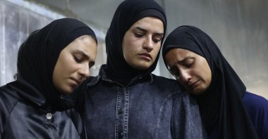 Mourners weep next to the body of one of the Palestinians who died in an Israeli airstrike in the Sabra neighborhood of Gaza City, Palestine, July 21, 2026. (AFP Photo)