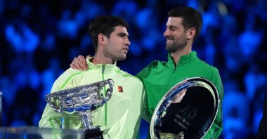 Spain's Carlos Alcaraz (L) holds the Norman Brookes Challenge Cup after defeating Serbia's Novak Djokovic in the men's singles final at the Australian Open tennis championship, Melbourne, Australia, Feb. 1, 2026. (AP Photo)
