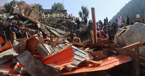 People inspect the destruction and look for belongings after floodwaters swept through Parun, the capital of Nuristan province, Afghanistan, July 21, 2026. (Reuters Photo)