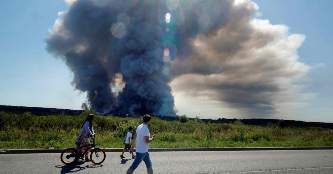 Local residents walk past the smoke of a fire at the Russian e-commerce firm Wildberries' logistics complexes, town of Elektrostal, outside Moscow, Russia, July 18, 2026. (AFP Photo)