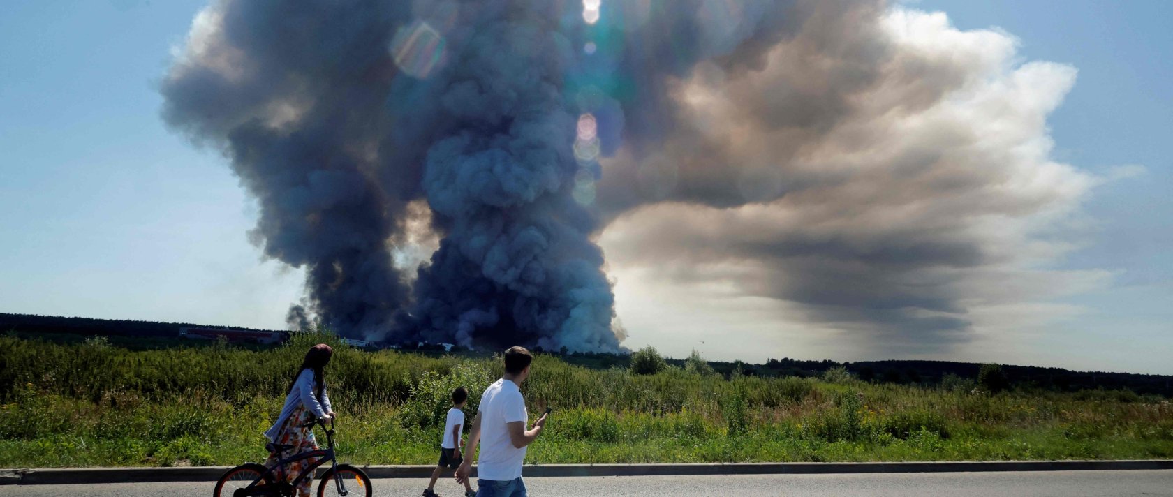 Local residents walk past the smoke of a fire at the Russian e-commerce firm Wildberries' logistics complexes, town of Elektrostal, outside Moscow, Russia, July 18, 2026. (AFP Photo)