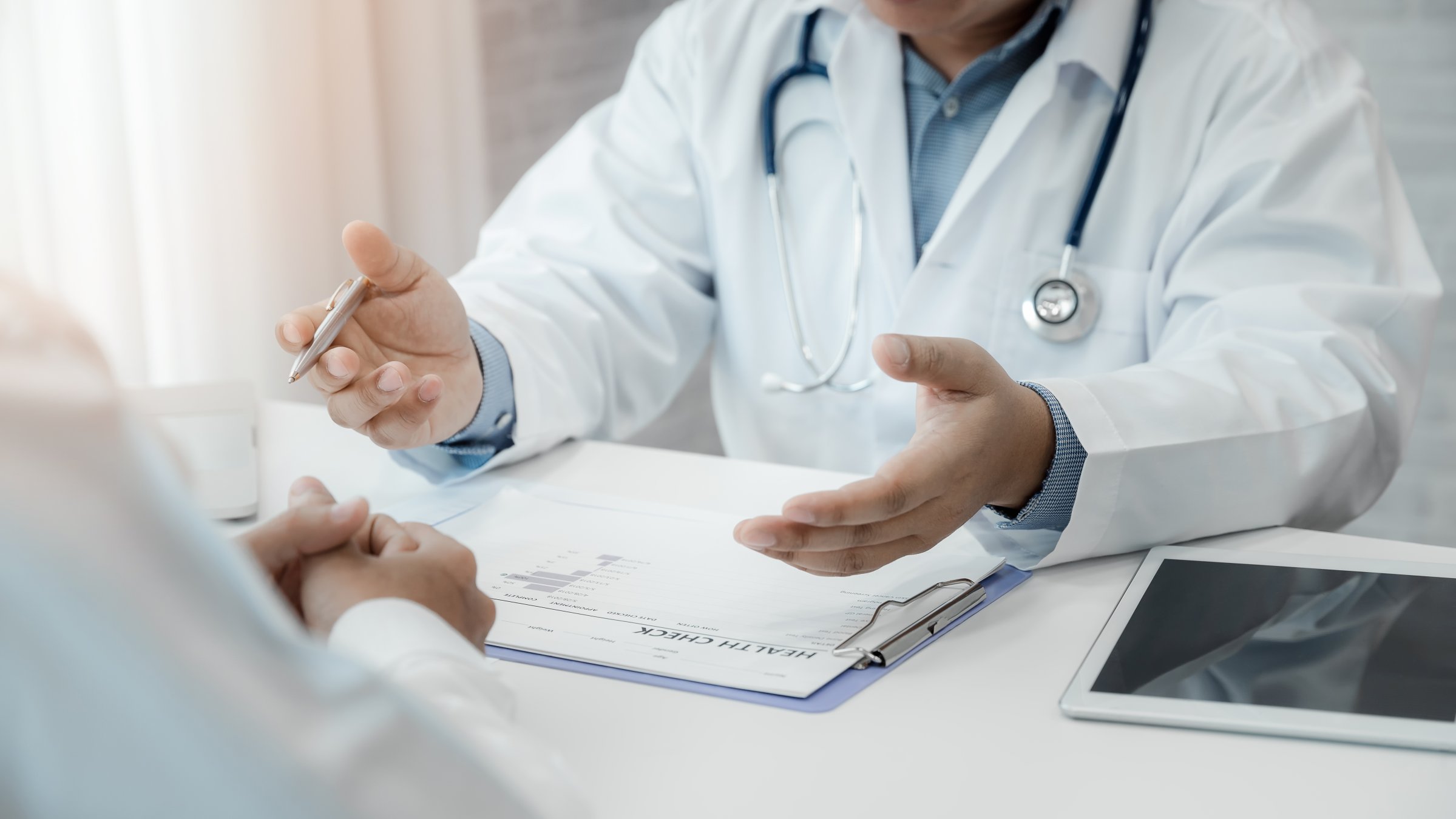 A doctor explaining test results to his patient. (Shutterstock Photo)