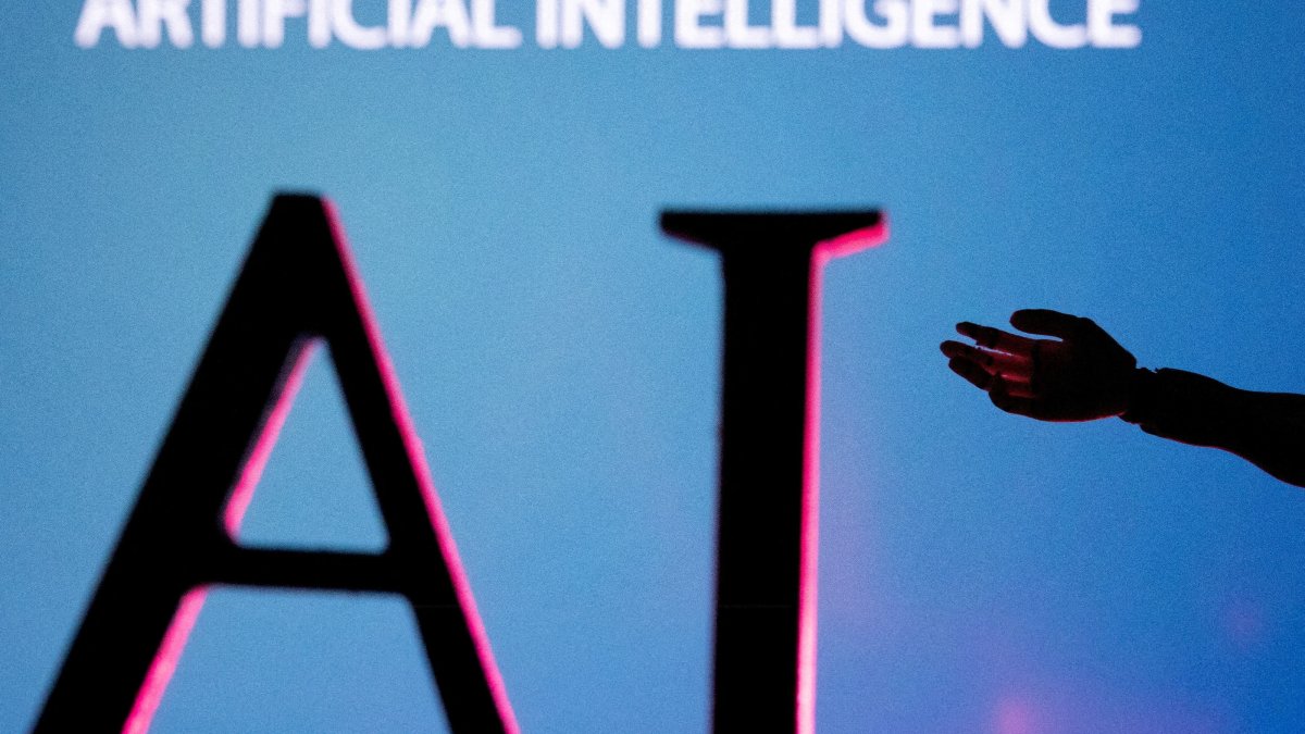 AI letters and robot hand miniature in this illustration taken, June 23, 2023. (Reuters Photo)