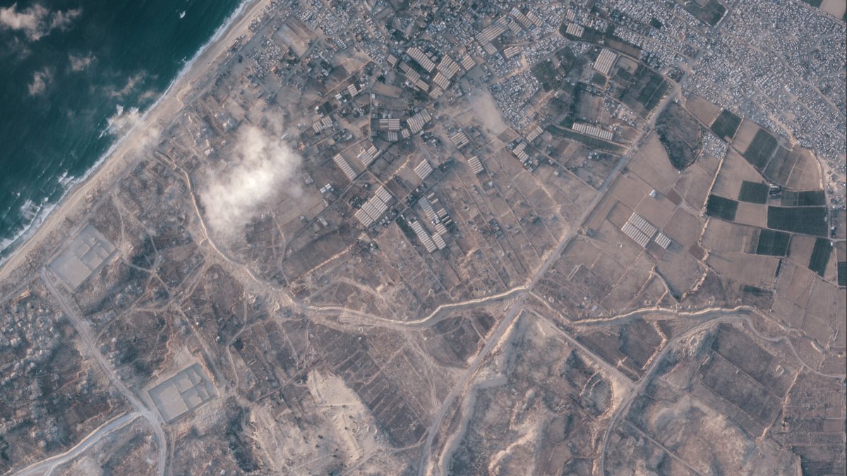 A satellite image from Planet Labs PBC shows a section of an earthen barrier, cutting horizontally across the middle of the image, being built by the Israeli military in the southern Gaza Strip, July 15, 2026. (AP Photo)