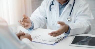 A doctor explaining test results to his patient. (Shutterstock Photo)