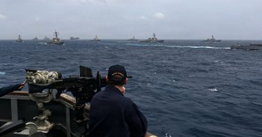 A U.S. Sailor aboard the Arleigh Burke-class guided-missile destroyer USS Frank E. Petersen Jr. observes a photo exercise in the Arabian Sea, July 15, 2025. (AFP Photo)