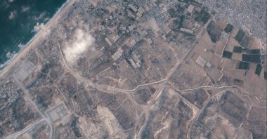 A satellite image from Planet Labs PBC shows a section of an earthen barrier, cutting horizontally across the middle of the image, being built by the Israeli military in the southern Gaza Strip, July 15, 2026. (AP Photo)