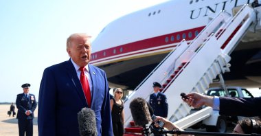 U.S. President Donald Trump stops to speak to reporters before boarding Air Force One en route to Dover Air Force Base, Maryland, July 22, 2026. (AFP Photo)