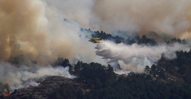 An airplane releases water above the wildfire of La Mierla in Condemios de Arriba, Guadalajara, Spain, July 22, 2026. (Reuters Photo)