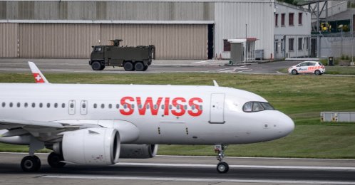 A Swiss Army vehicle and a police car pass behind the tail of a Swiss International Air Lines aircraft during a patrol on the tarmac at Geneva Airport ahead of the upcoming G7 summit in nearby Evian, in Geneva, June 11, 2026. (AFP File Photo)