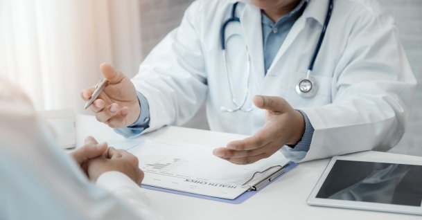 A doctor explaining test results to his patient. (Shutterstock Photo)