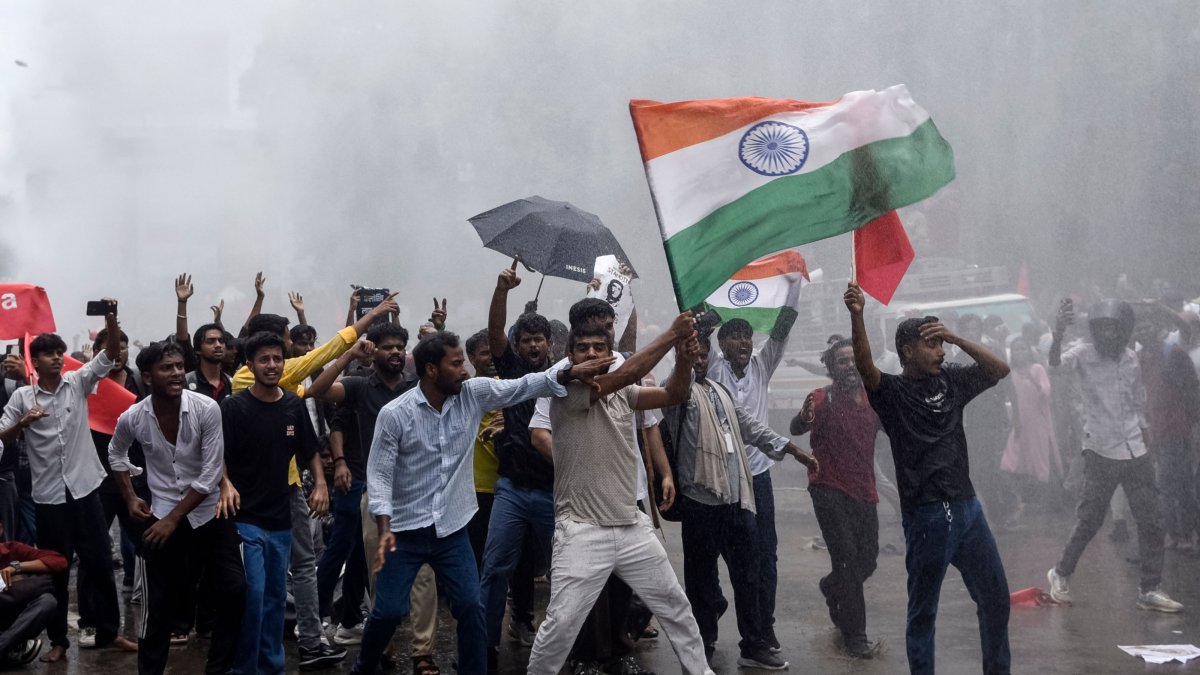 Demonstrators carrying the Indian national flag shout slogans during a protest march demanding the resignation of India’s Education Minister Dharmendra Pradhan in Patna, India, July 22, 2026. (AFP Photo)