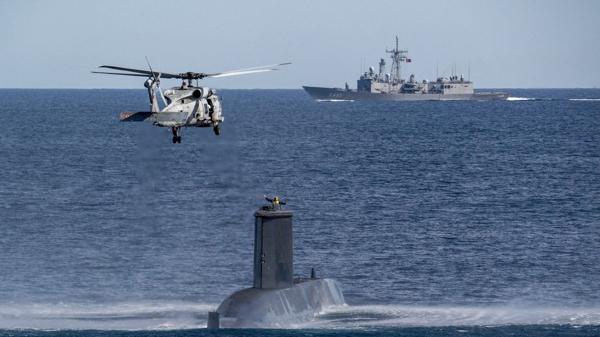 A Turkish naval helicopter, ship and submarine take part in a warfare exercise off the coast of Catania, Sicily, southern Italy,  Feb. 26, 2024. (AP Photo)