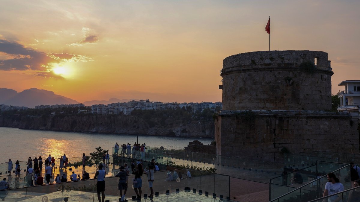 Visitors watch the sunset from the viewing terrace at the restored Hıdırlık Tower archaeological site, Antalya, Türkiye, July 21, 2026. (IHA Photo)
