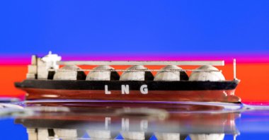 Model of LNG tanker is seen in front of Russia's flag in this illustration taken, May 19, 2022. (Reuters Photo)