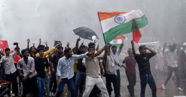 Demonstrators carrying the Indian national flag shout slogans during a protest march demanding the resignation of India’s Education Minister Dharmendra Pradhan in Patna, India, July 22, 2026. (AFP Photo)