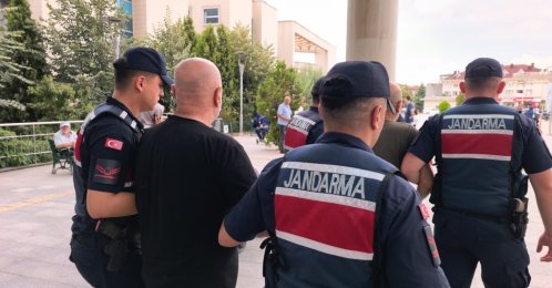 Turkish director Ezel Akay is escorted by gendarmerie officers after being detained during a drug operation, Bursa, Türkiye, July 23, 2026. (DHA Photo)
